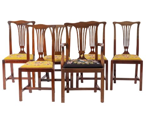 A group of six mahogany dining chairs in George III style, early 20th century; the elbow chair associated; all with fluted va