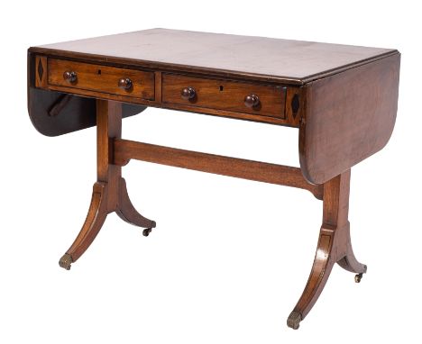 A Regency mahogany and inlaid sofa table, bordered with boxwood and ebony lines, the crossbanded hinged top with rounded corn