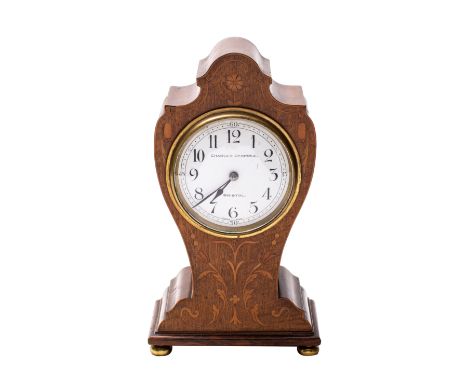 A Edwardian mahogany balloon clock the French eight-day duration movement having a platform lever escapement with the round w