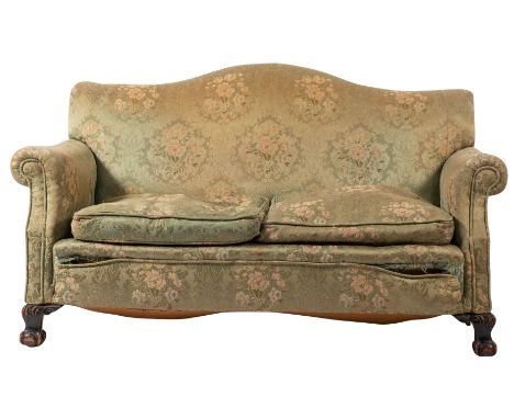 An upholstered suite of seat furniture, early 20th century; comprising sofa and twin armchairs; all with camel backs and outs