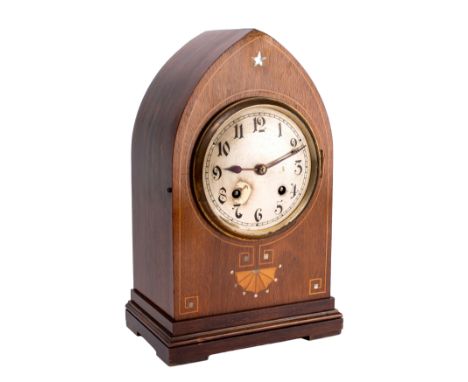 An Edwardian mantel clock the eight-day duration movement striking the hours and the quarters on two gongs, the round silvere