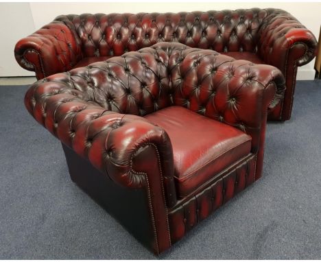 CHESTERFIELD SOFA AND MATCHING CLUB ARMCHAIRin ox blood leather, both with button backs and scroll arms, with decorative stud