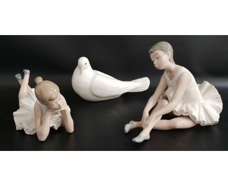 THREE NAO FIGURINEScomprising a seated ballerina adjusting her shoe, 14cm high, a ballerina lying down, 22cm long, and a seat