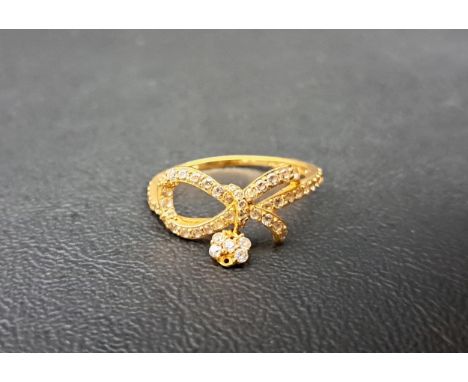 CZ SET TWENTY-ONE CARAT GOLD RINGof bow design with cluster drop, ring size P-Q and approximately 2.1 grams 