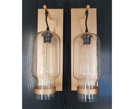 PAIR OF BRASS HALL LIGHTSwith rectangular brass wall plate and arm, the shaped cylindrical glass shade with decorative long c