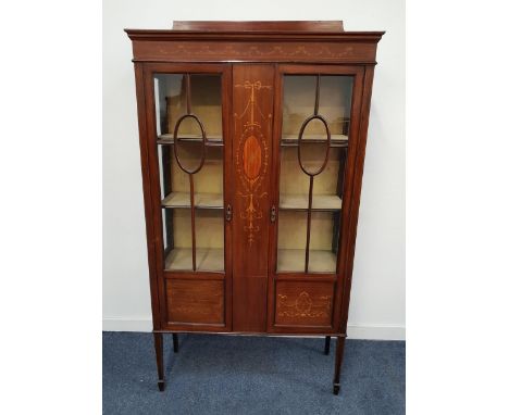 EDWARDIAN MAHOGANY AND INLAID DISPLAY CABINETwith a central panel inlaid with a bow, flowers and husks, flanked by a pair of 