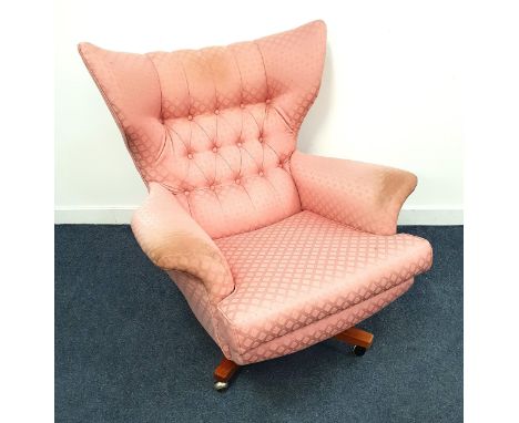 1950s WING BACK ARMCHAIRwith a button back on a rotating base with casters 