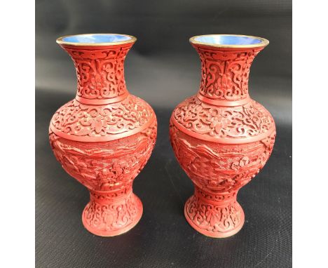 PAIR OF CHINESE CINNIBAR VASESwith ornate decoration, the bases later drilled for lamp wiring, 20.5cm high (2) 