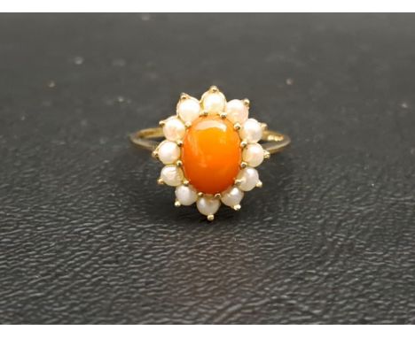 CORAL AND PEARL CLUSTER DRESS RINGthe central oval coral cabochon in twelve pearl surround, on nine carat gold shank, ring si
