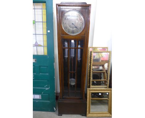 A 1930's oak triple weight longcase clock