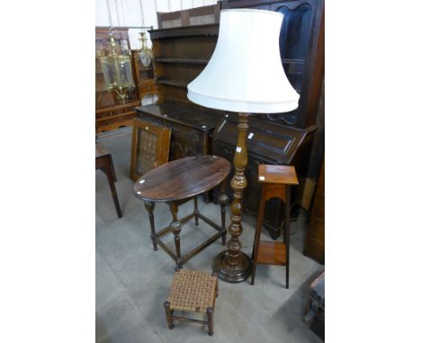 An oval oak occasional table, walnut standard lamp, stool and jardiniere stand