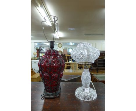 A cut glass table lamp and a red glass table lamp base