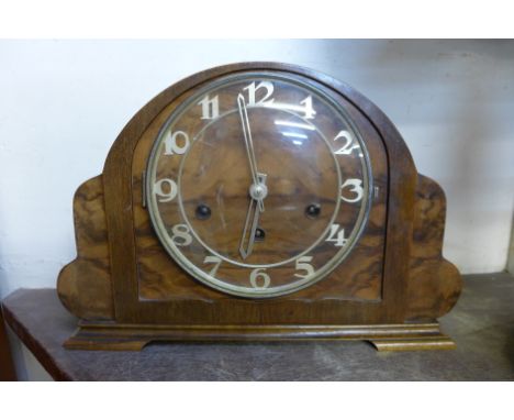 An Art Deco mahogany and walnut mantel clock