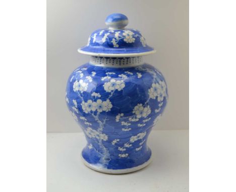 A 19TH CENTURY LARGE SIZED CHINESE BALUSTER VASE hand painted in prunus and cracked ice, having a knop handled lid, the under