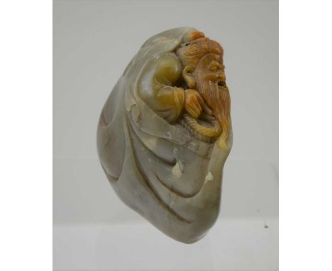 A CHINESE JADE / HARDSTONE PEBBLE CARVING, the sculptor has released an image of a bearded wiseman from the corner of the sto