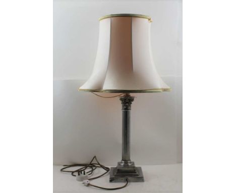 A PLATED CORINTHIAN DESIGN TABLE LAMP, raised on square stepped base, 36.5cm high (from the top of the capital to the base) 