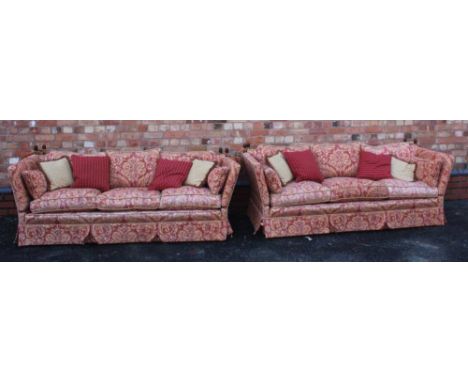 A PAIR OF KNOLE DESIGN PETER GUILD BRANDED THREE PERSON SETTEES, having old gold and dusky red chenille type fabric upholster