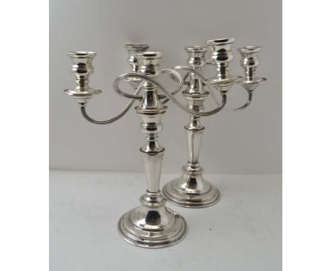 A PAIR OF SILVER ON COPPER CANDELABRA of Georgian design, each stick with a removable twin branch, having three nozzle mount,