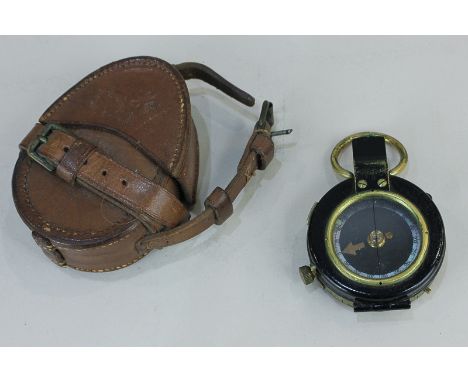 A World War I compass in leather case, marked No 111704 1917