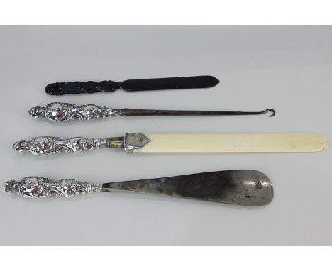 A set of three Edward VII silver mounted tools, button book, shoe horn, and letter opener with ivory blade, possibly by Gilbe