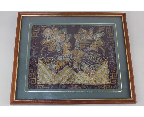 A Chinese embroidered patchwork panel of a bird and flowers, 19cm by 24cm
