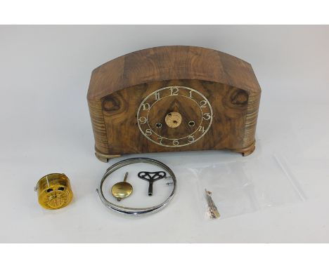 An early 20th century walnut mantel clock with Roman numerals on pierced circular dial, the movement striking on a gong (a/f)