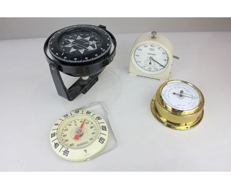 A small collection of navigational sailing equipment to include a Heath Marine gimballed compass, a Smith & Sons stop clock i