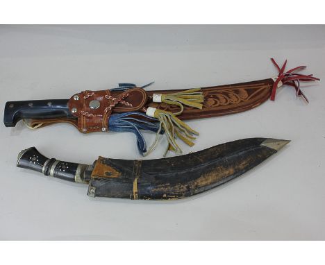 A Kukri in leather scabbard together with a machete from Central America in decorative scabbard