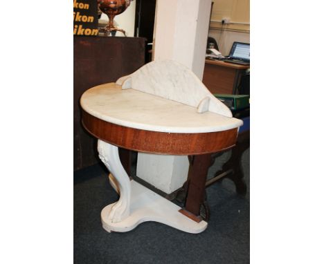 A painted wood and marble top console table with raised back and demi-lune top, with claw foot front support, on shaped platf