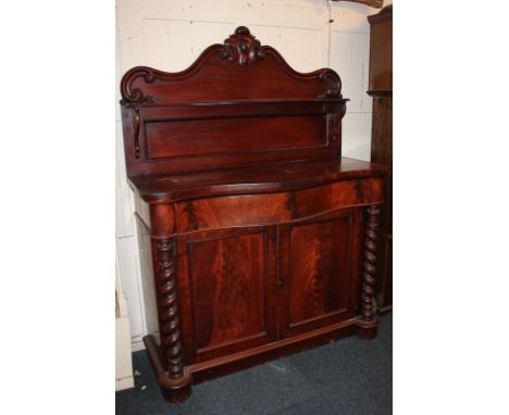 A Victorian mahogany serpentine chiffonier, with scrolling raised back and single curved shelf, drawer and cupboard beneath, 