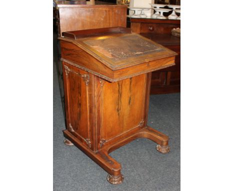 A Victorian rosewood Davenport wit satinwood lined interior, fitted stationary drawer to the side on hinge, with four side dr