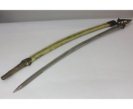 An Indian curved steel sword with brass pommel and guard, the 79cm blade etched with floral design, in velvet and brass scabb