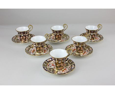 A Royal Crown Derby porcelain coffee set of six cups and saucers in the Imari pattern (one broken handle)