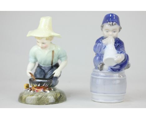 A Royal Copenhagen figure  of a boy wearing a fez, with a megaphone, 11cm high, together with a Royal Doulton porcelain figur