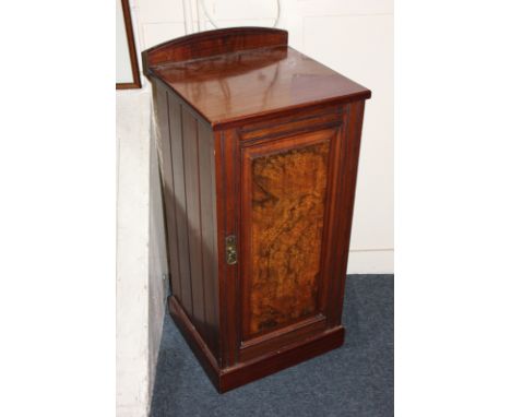 A walnut bedside cupboard with shelf enclosed by single panel door, on plinth base, 37.5cm