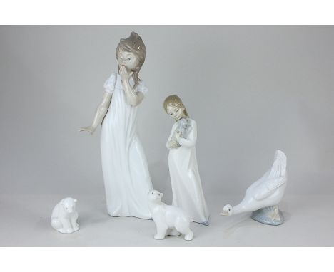 Two Nao porcelain figures of girls, one in a nightdress, the other with a puppy, a pair of Nao polar bears, and a duck, talle