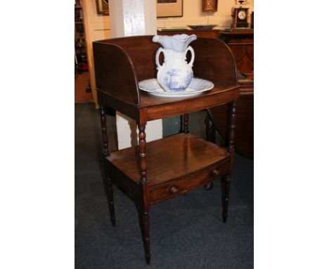 A 19th century rectangular mahogany wash stand, with shelf and drawer, on turned legs, 60cm, and a blue and white stoneware w