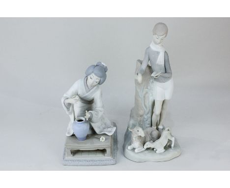 A Lladro porcelain figure of a boy reading, with sheep and lamb, 28cm high, together with a Lladro porcelain figure of a knee