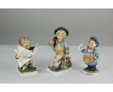 Three Goebel Hummel figures comprising boy with hat and umbrella 'Merry Wanderer', boy delivering letters 'Postman', and boy 