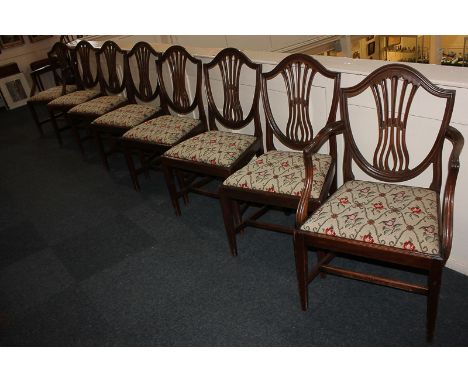 A set of eight mahogany shield back dining chairs including two carvers, each with central pierced back splat and tapestry up