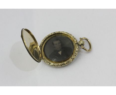 A Victorian gold watch case locket, engine turned with a foliate carved border