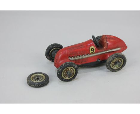 A Schuco Studio clockwork tin plate mechanical toy racing car, model No 1050, with number 9 decal (a/f), and spare wheel, no 