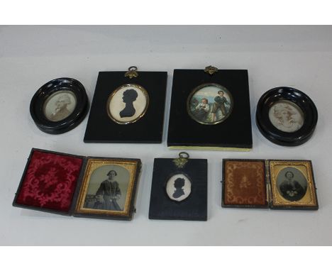 Two 19th century silhouettes, two black and white photographs and gilt and leather folding frames, a pair of portrait miniatu