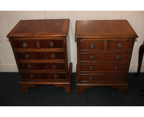 A pair of small yew wood chests of two short over three long drawers, on bracket feet, each 41.5cm, (a/f)