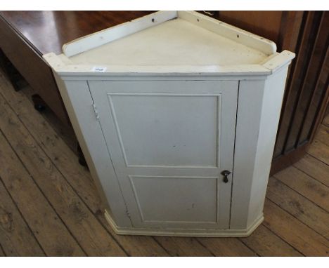 A painted corner cabinet