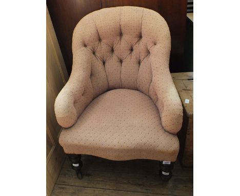 A Victorian button back cream upholstered nursing chair on turned legs