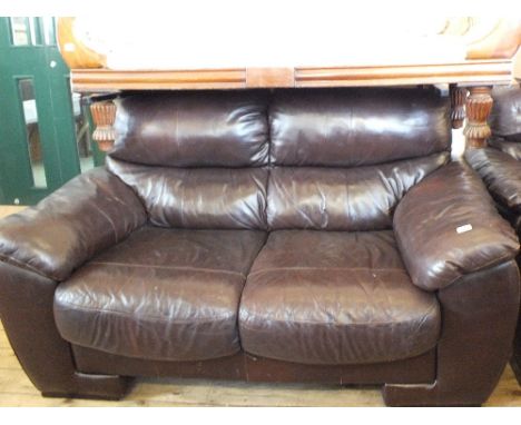 A modern brown leather two seat sofa