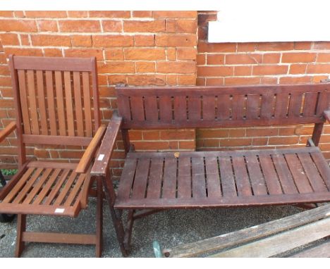 A wooden garden bench and a folding chair