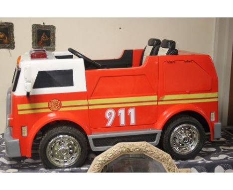 A CHILDS FIRE ENGINE MISSING HEADLIGHT