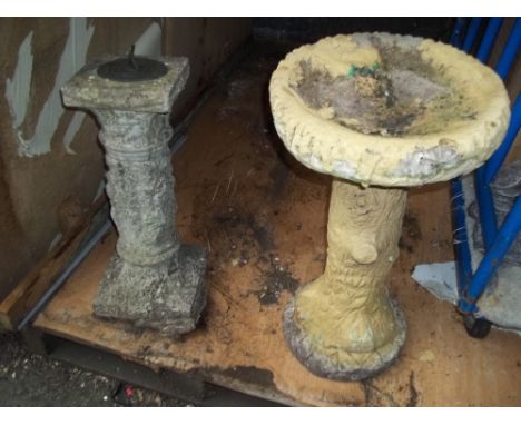 A CONCRETE BIRD BATH AND A SUNDIAL